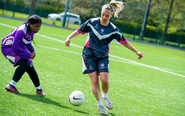 Two women playing football