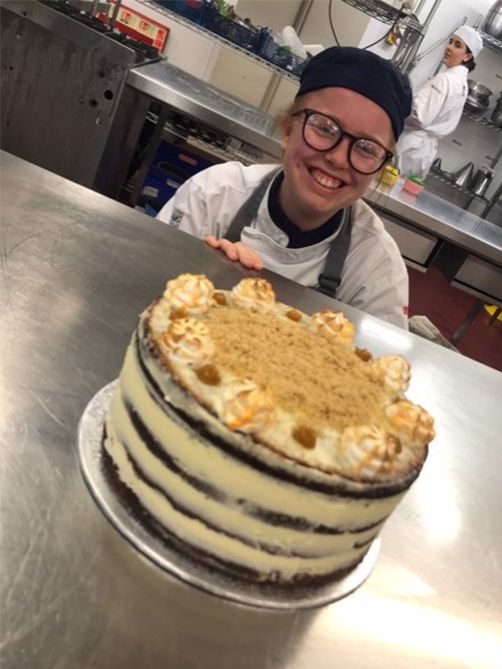 Young Chef presenting a cake