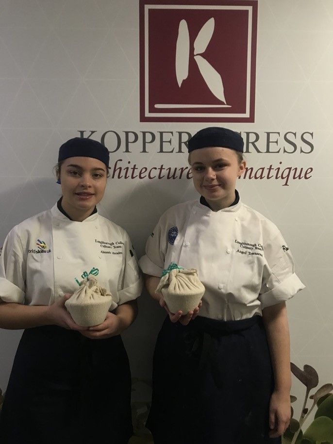 Young student chefs standing in front of Koppert Cress sign