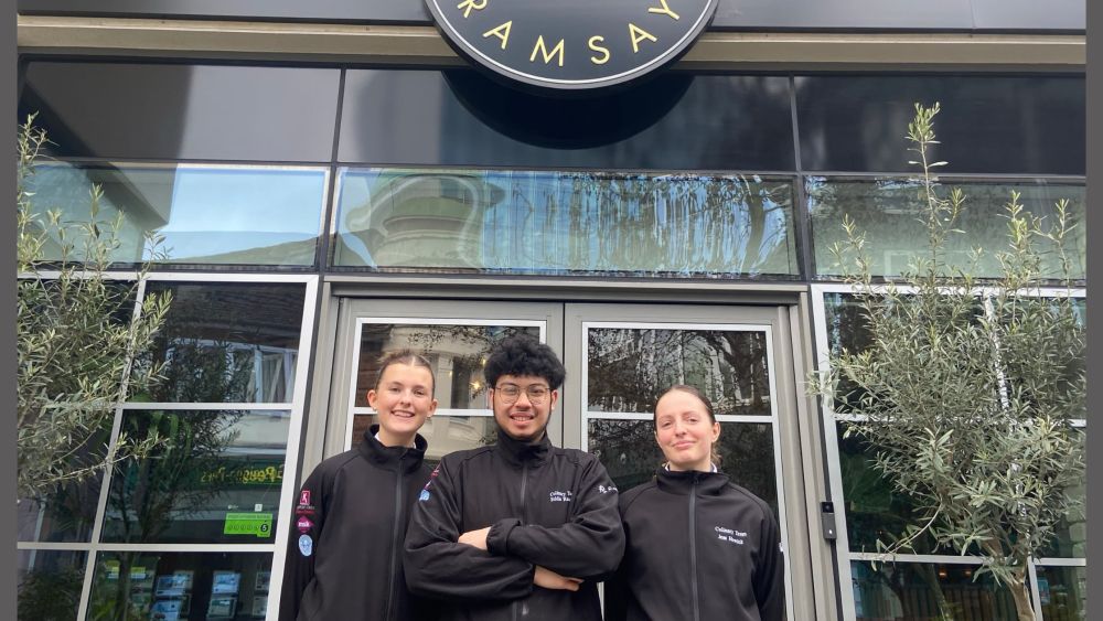 Catering learners Jess, Eddie, and Libby outside the Gordon Ramsay Academy
